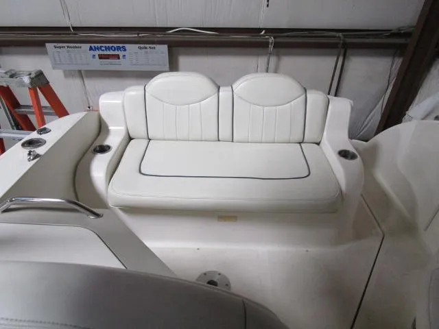 Slide: The Image of 2006 Sea Ray 240 Sundancer cabin interior with seating, sink, and microwave. - 9