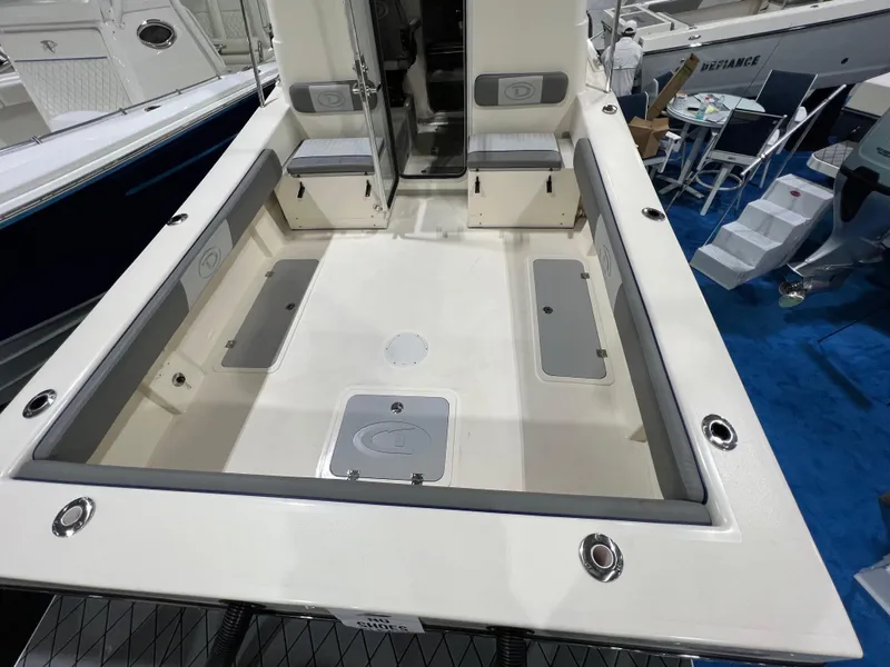Slide: The Image of 2024 Defiance Admiral 250 EX boat deck with seating and storage compartments. - 13