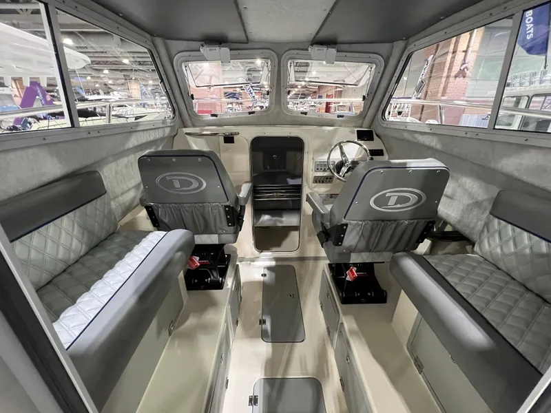 Slide: The Image of 2024 Defiance Admiral 250 EX boat interior with seating and steering console. - 16