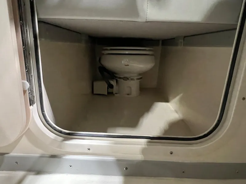 Slide: The Image of 2024 Defiance Admiral 250 EX boat interior with compact marine toilet. - 18