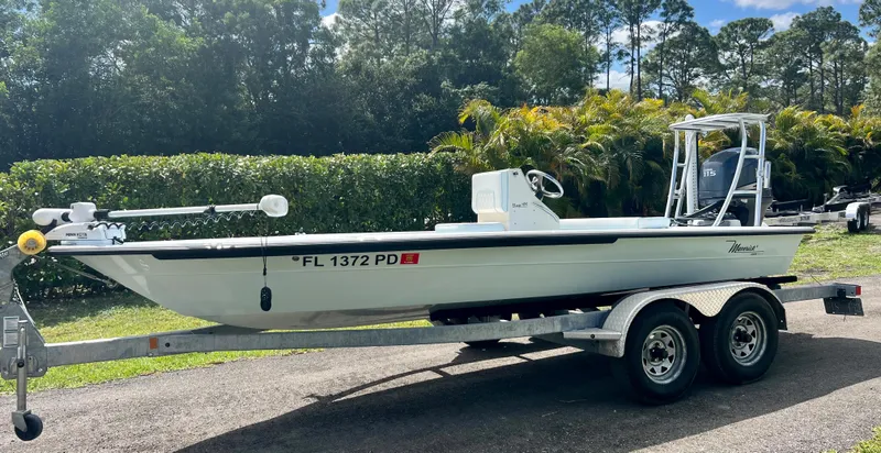 Slide: The Image of 2011 Maverick 18 HPX-V boat on a trailer in a sunny outdoor setting. - 0