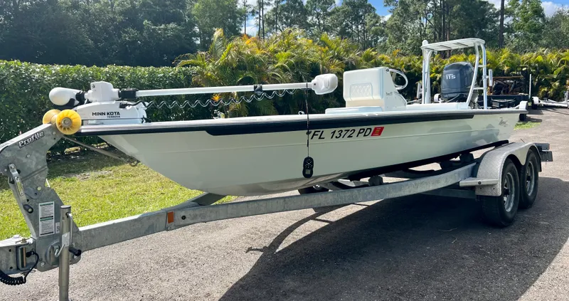 Slide: The Image of 2011 Maverick 18 HPX-V boat on a trailer in a sunny outdoor setting. - 1
