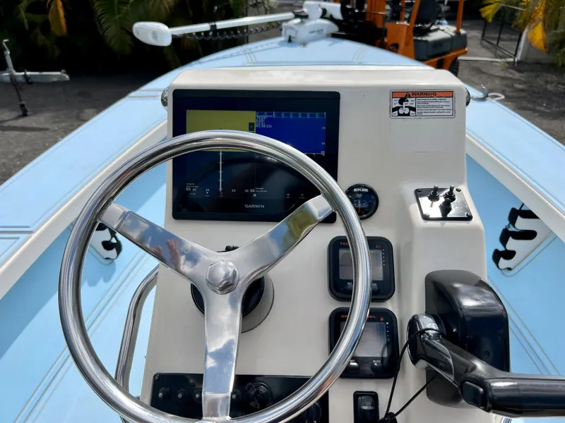 Slide: The Image of 2011 Maverick 18 HPX-V boat console with steering wheel and navigation display. - 12