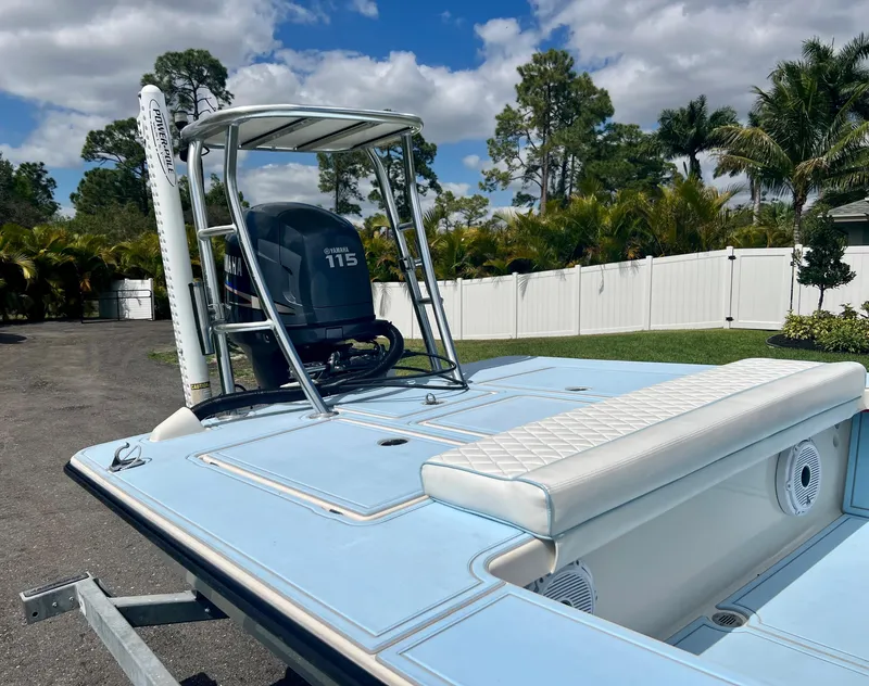 Slide: The Image of 2011 Maverick 18 HPX-V boat with Yamaha 115 engine, light blue deck, and white seating. - 15