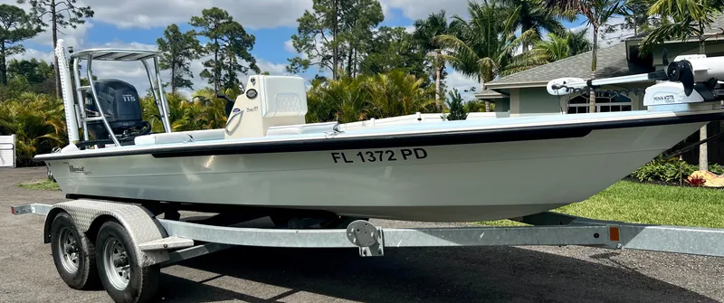 Slide: The Image of 2011 Maverick 18 HPX-V boat on a trailer in a residential driveway. - 5