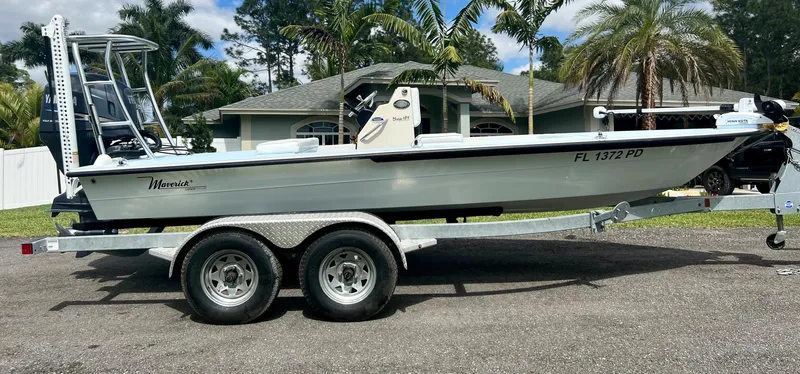 Slide: The Image of 2011 Maverick 18 HPX-V boat on a trailer in a residential area. - 6