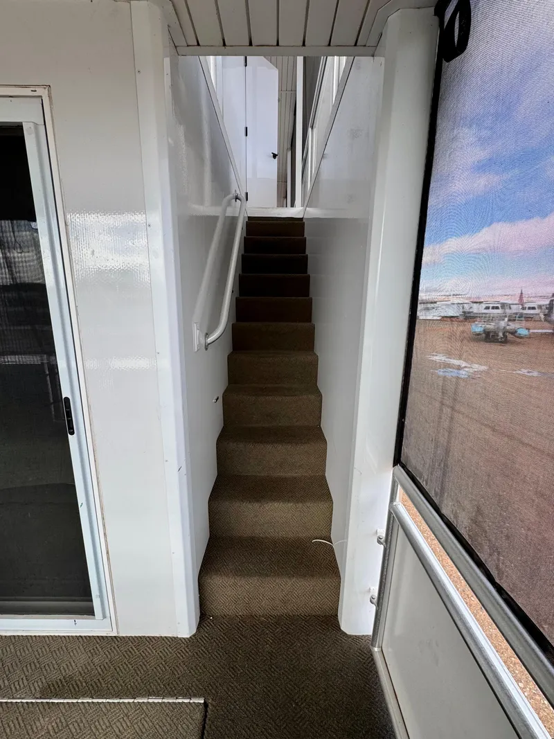 Slide: The Image of Staircase inside 2021 Adonia Solace Trip #10 houseboat with carpeted steps and white walls. - 14