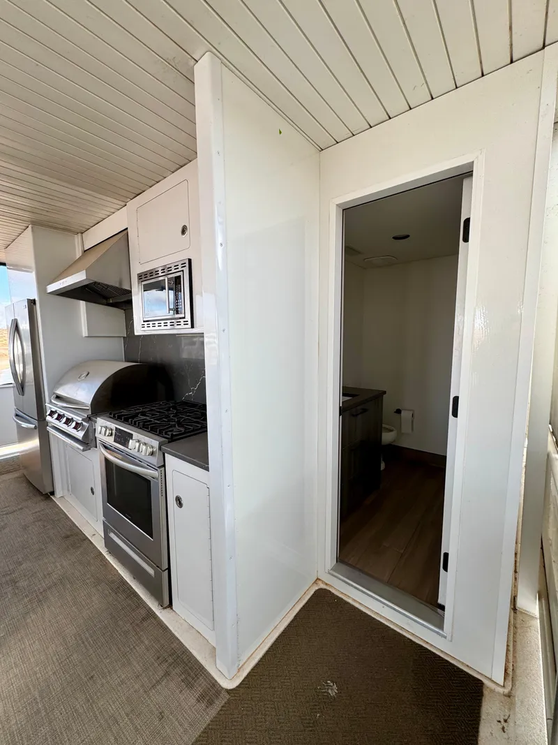 Slide: The Image of Modern outdoor kitchen on Adonia Solace Trip #10, 2021 model, featuring grill and oven. - 21