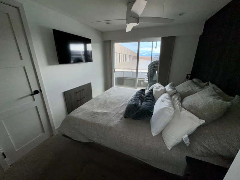 Slide: The Image of Modern bedroom in Adonia Solace Trip #10, 2021 model, featuring a cozy bed and wall-mounted TV. - 8