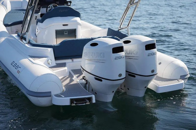 Slide: The Image of 2025 2 Bar 8.2 boat with twin Suzuki 200 outboard engines on water. - 11