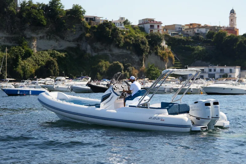 Slide: The Image of 2025 2 Bar 8.2 inflatable boat cruising in a scenic coastal area. - 13
