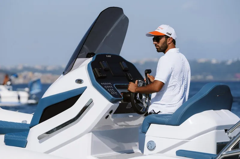 Slide: The Image of Man driving a 2025 2 Bar 8.2 boat on a sunny day. - 17