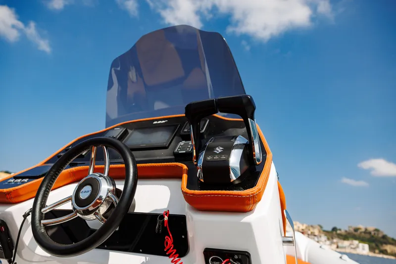 Slide: The Image of 2025 2 Bar 8.2 boat dashboard with steering wheel and throttle control. - 28