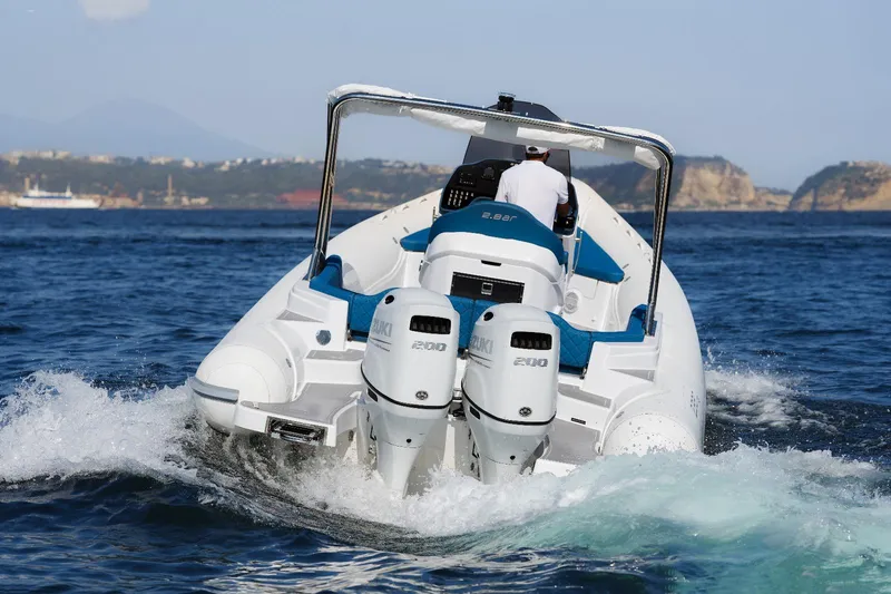 Slide: The Image of 2025 2 Bar 8.2 boat with dual outboard engines cruising on the water. - 3