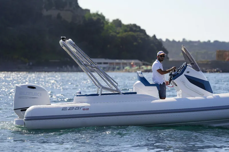 Slide: The Image of 2025 2 Bar 8.2 boat on water with a person steering. - 4