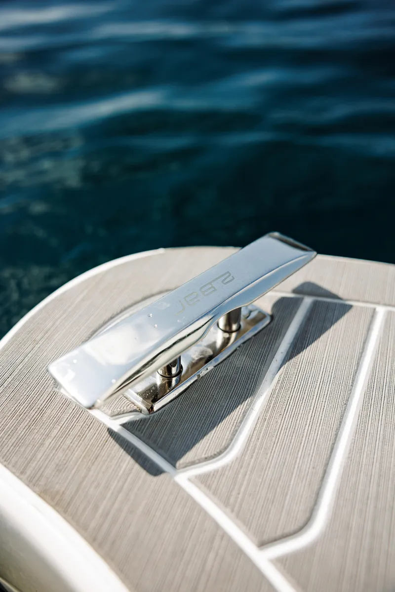 Slide: The Image of Close-up of 2025 2 Bar 8.2 boat cleat on deck with water background. - 5