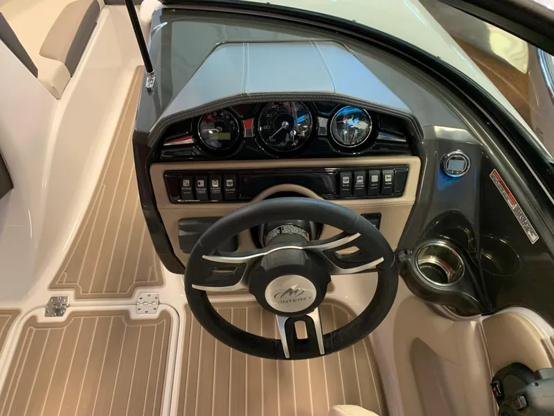 Slide: The Image of 2023 Monterey 224FS boat dashboard with steering wheel and control panel. - 6