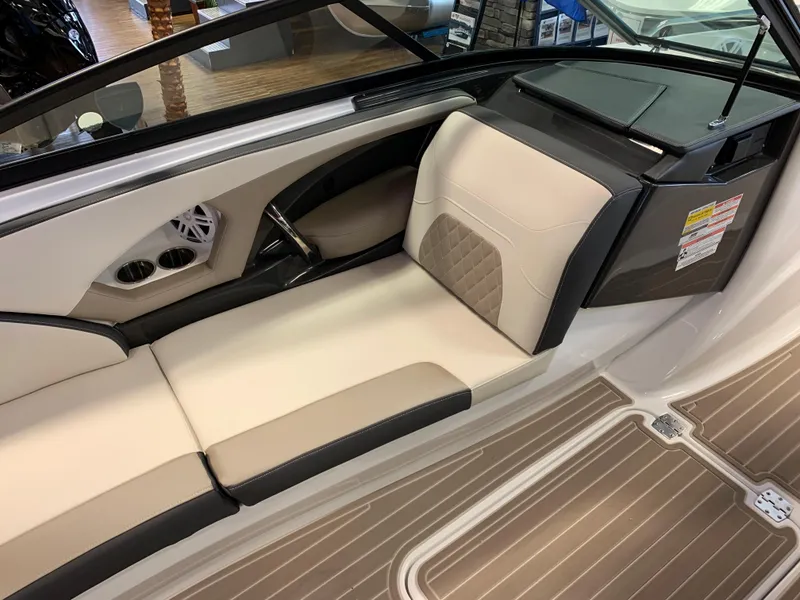 Slide: The Image of 2023 Monterey 224FS boat interior with beige and black seating. - 7