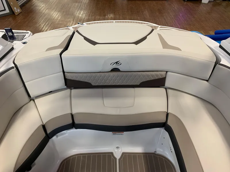 Slide: The Image of 2023 Monterey 224FS boat interior seating with beige and brown upholstery. - 9