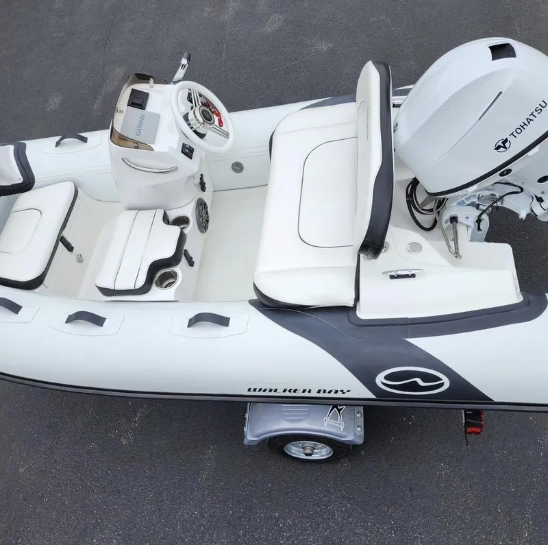 The Image of 2025 Walker Bay Generation 10 LTE boat with Tohatsu engine, white interior, and steering console. - 0