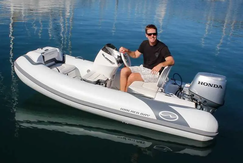 Slide: The Image of 2025 Walker Bay Generation 10 LTE boat with Honda outboard motor on water. - 12