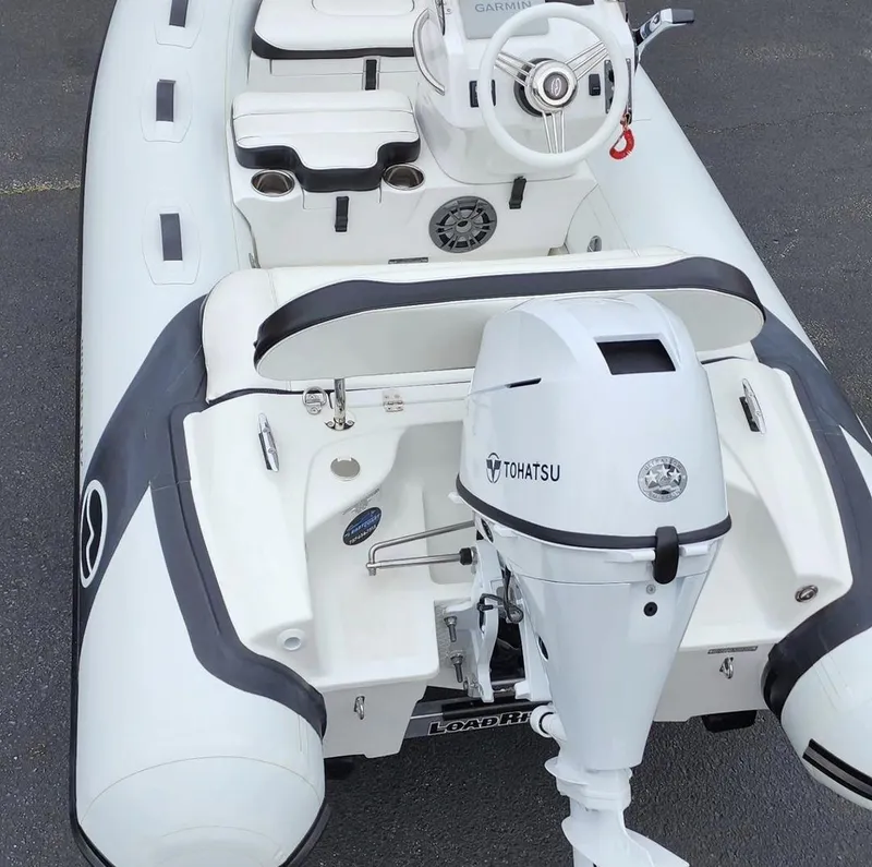 Slide: The Image of 2025 Walker Bay Generation 10 LTE inflatable boat with Tohatsu outboard motor. - 2