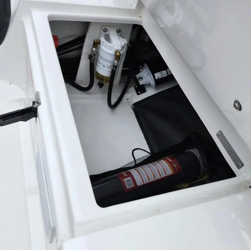Slide: The Image of Open storage compartment of 2025 Walker Bay Generation 10 LTE boat showing equipment and wiring. - 6