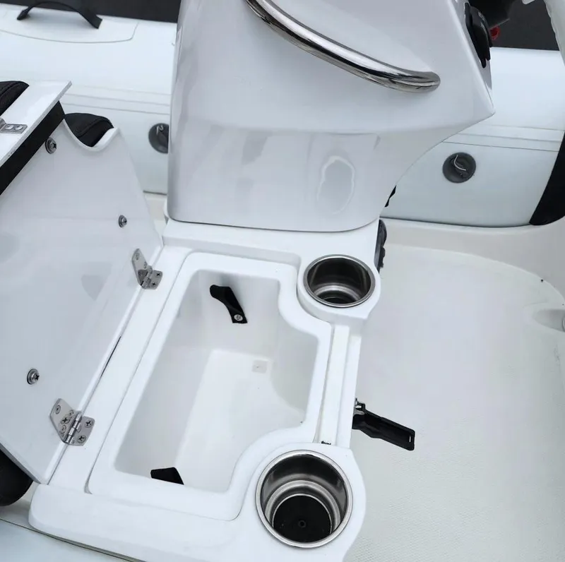Slide: The Image of Walker Bay Generation 10 LTE 2025 boat console with open storage compartment and cup holders. - 7