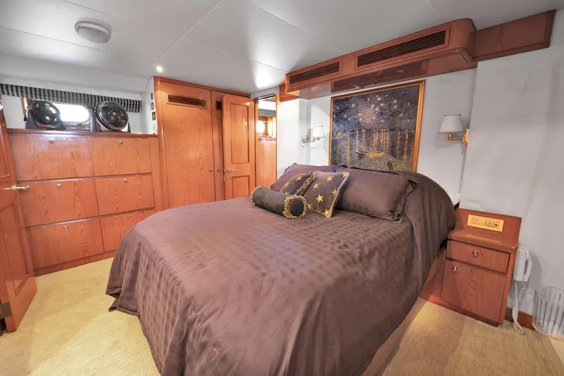 Slide: The Image of Luxurious bedroom in 2001 Cheoy Lee Expedition 70 yacht with elegant wood finishes. - 12