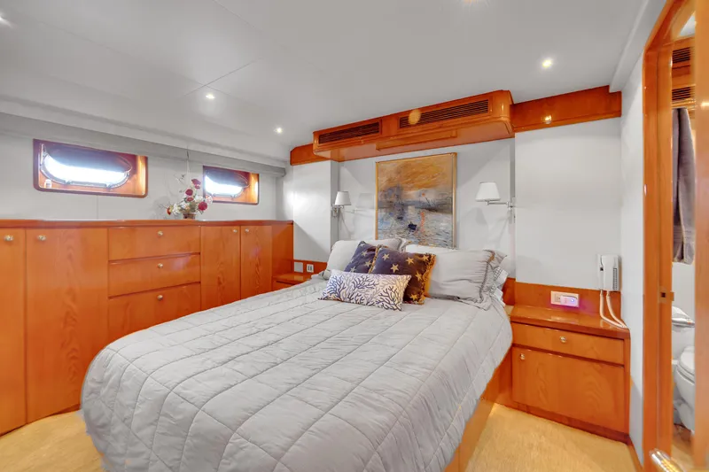 Slide: The Image of Luxurious bedroom interior of 2001 Cheoy Lee Expedition 70 yacht with elegant wood finishes. - 15