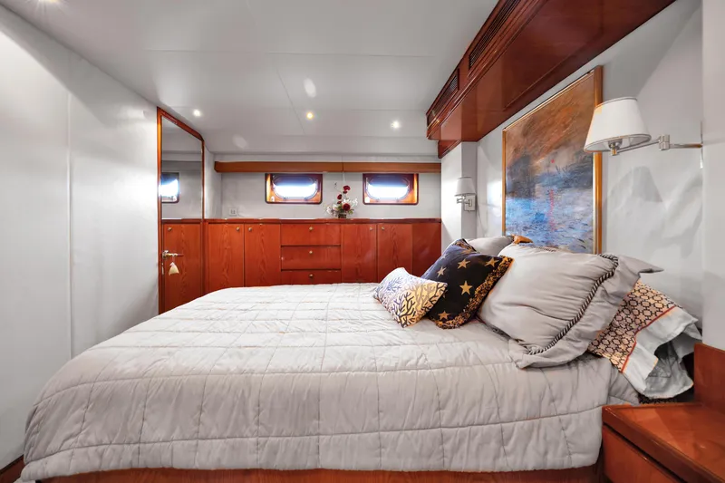 Slide: The Image of Luxurious bedroom interior of 2001 Cheoy Lee Expedition 70 yacht with elegant wood finishes. - 16