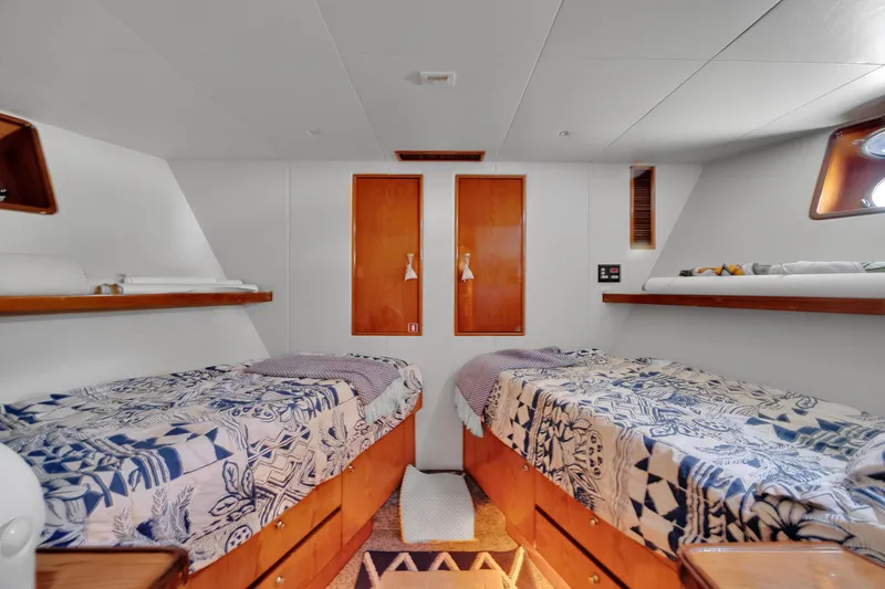 Slide: The Image of Twin cabin interior of 2001 Cheoy Lee Expedition 70 yacht, featuring cozy beds and wooden accents. - 18