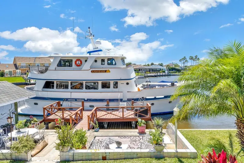 Slide: The Image of Cheoy Lee Expedition 70 yacht docked by a scenic waterfront, 2001 model. - 2