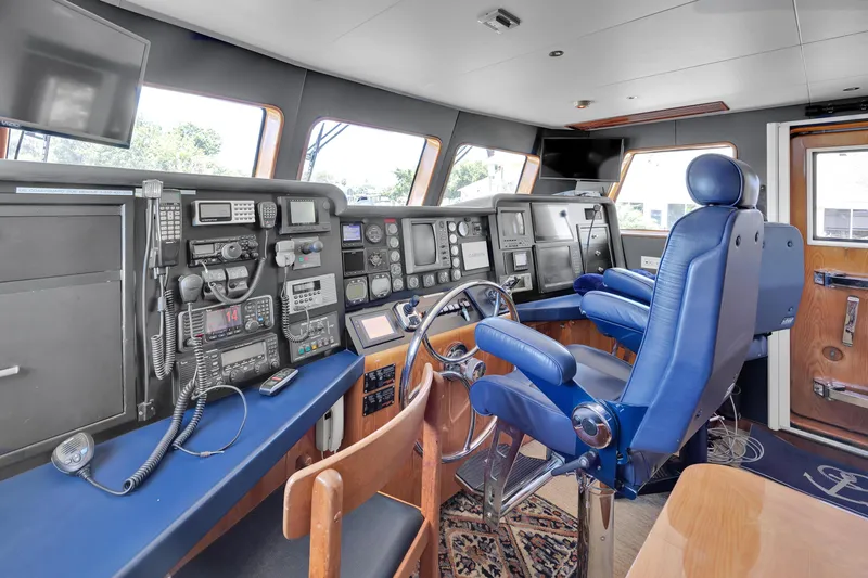 Slide: The Image of Cockpit of 2001 Cheoy Lee Expedition 70 yacht with blue seating and navigation equipment. - 3