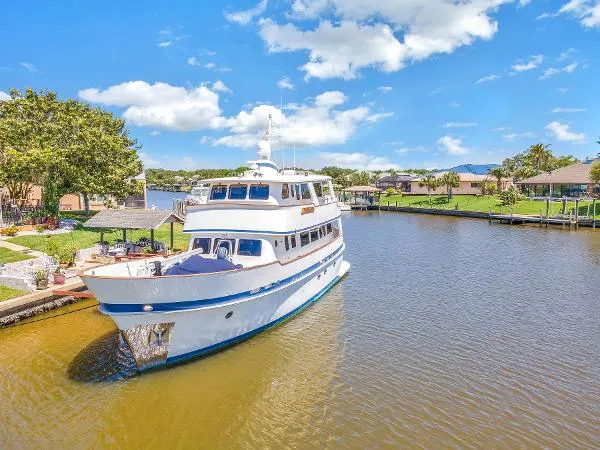 Slide: The Image of 2001 Cheoy Lee Expedition 70 yacht docked in a scenic canal setting. - 35