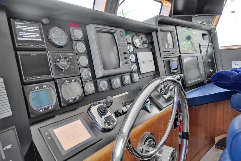 Slide: The Image of Control panel of 2001 Cheoy Lee Expedition 70 yacht with navigation instruments and steering wheel. - 4