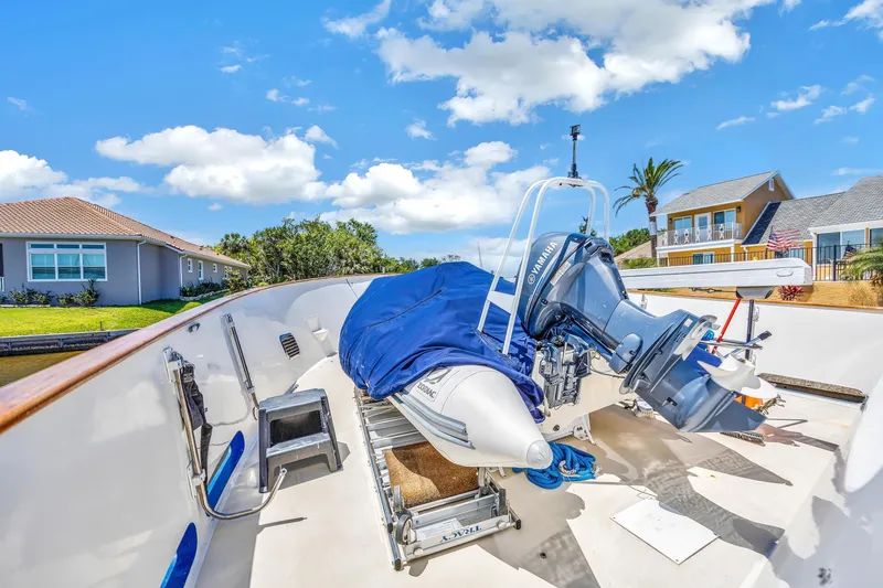 Slide: The Image of Cheoy Lee Expedition 70 yacht deck with inflatable boat, sunny day, residential backdrop. - 41