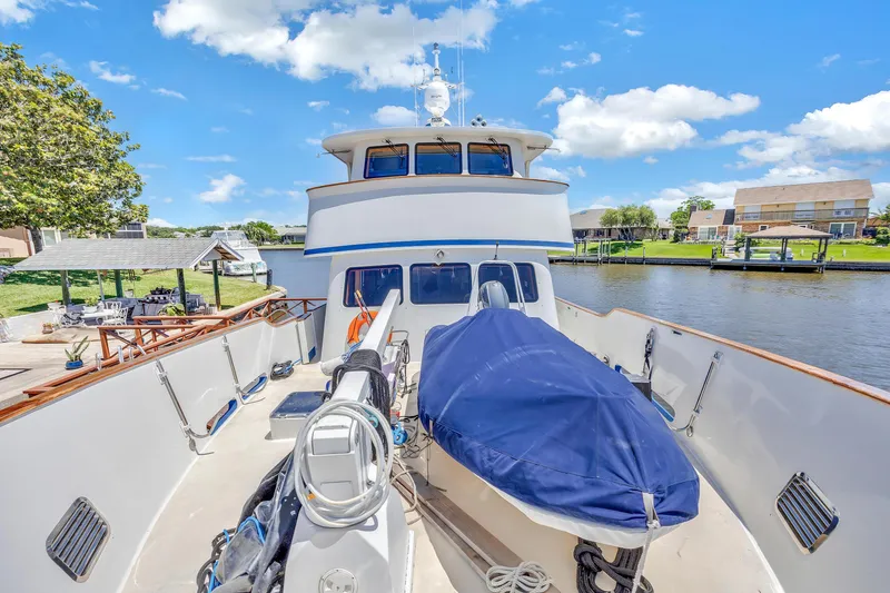 Slide: The Image of Cheoy Lee Expedition 70 yacht, 2001 model, docked by a scenic waterfront. - 42