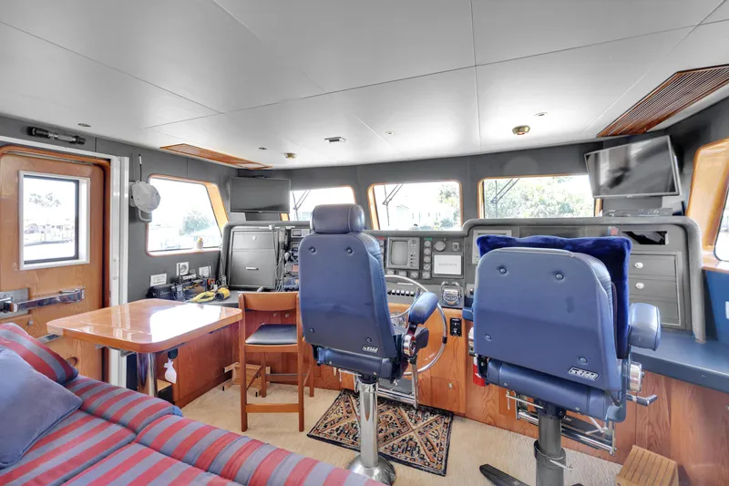 Slide: The Image of Interior of 2001 Cheoy Lee Expedition 70 yacht, featuring helm and seating area. - 5