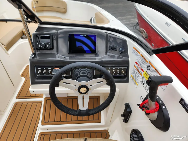 Slide: The Image of 2023 Bayliner VR4 boat dashboard with steering wheel and navigation controls. - 10