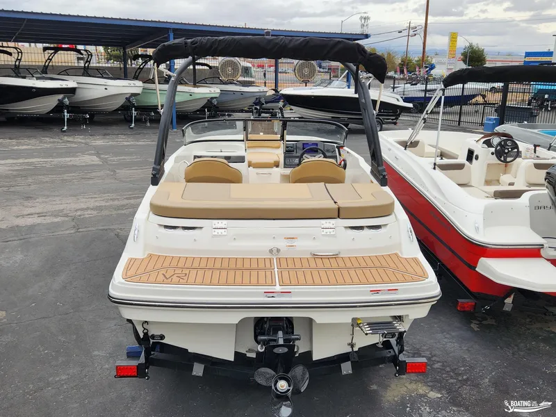 Slide: The Image of 2023 Bayliner VR4 boat, rear view, in a marina with other boats. - 3