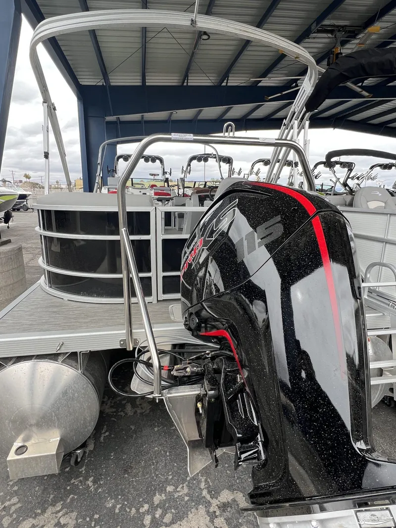 Slide: The Image of 2023 Bennington 21SXSRC pontoon boat with powerful outboard motor in a showroom. - 3