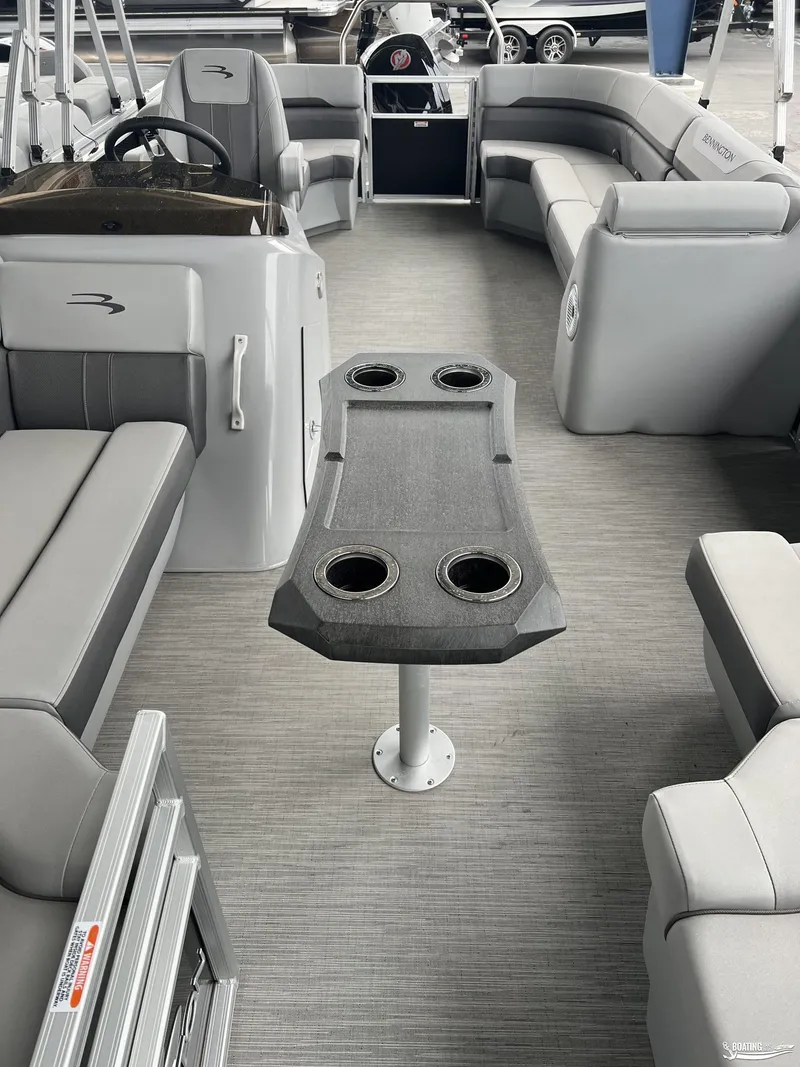 Slide: The Image of 2023 Bennington 21SXSRC pontoon boat interior with gray seating and central table. - 4
