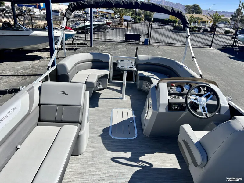 Slide: The Image of 2023 Bennington 21SXSRC pontoon boat interior with seating and steering console. - 6