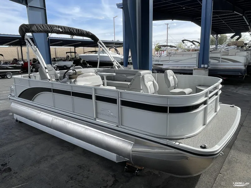 Slide: The Image of 2023 Bennington 21SF pontoon boat displayed in a showroom. - 2