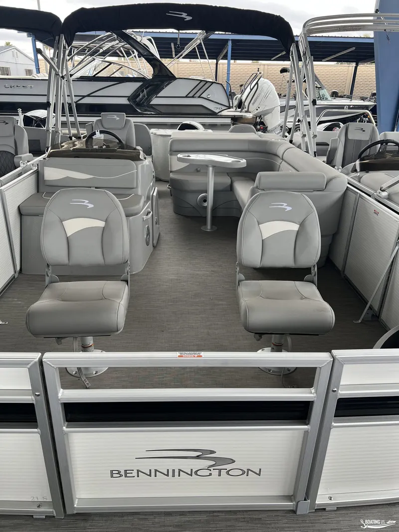 Slide: The Image of 2023 Bennington 21SF pontoon boat interior with gray seating and table. - 4