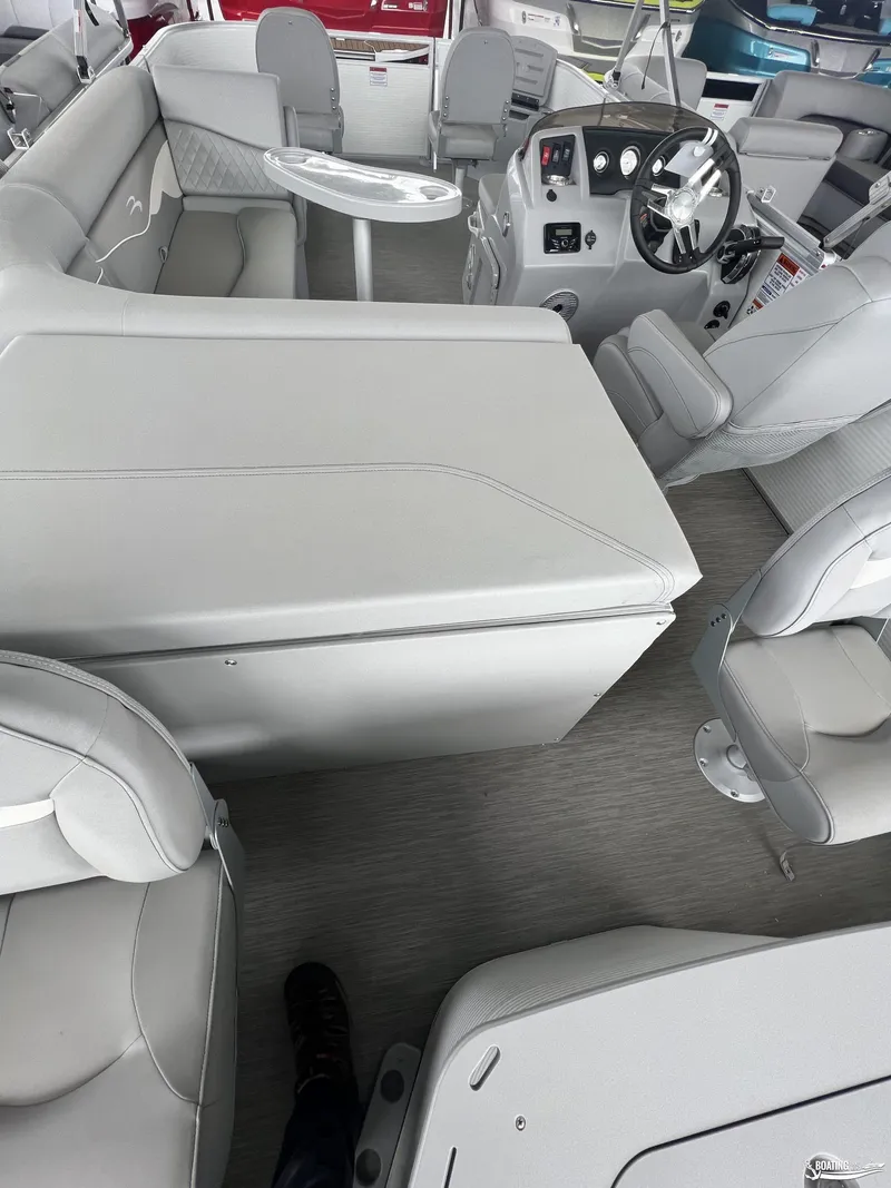 Slide: The Image of 2023 Bennington 21SF boat interior with gray seating and modern dashboard. - 5