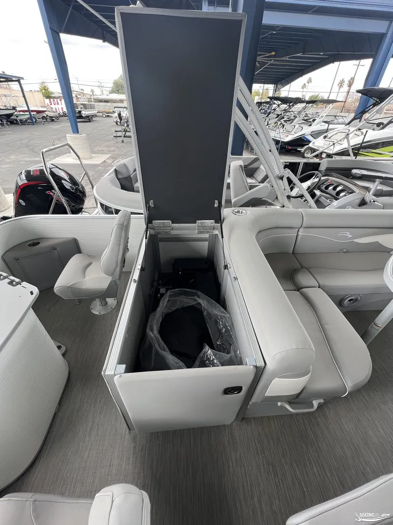 Slide: The Image of 2023 Bennington 21SF boat interior with open storage compartment and seating. - 6