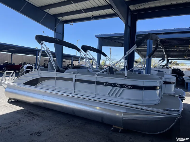 Slide: The Image of 2023 Bennington 23LSB pontoon boat under a covered dock. - 2