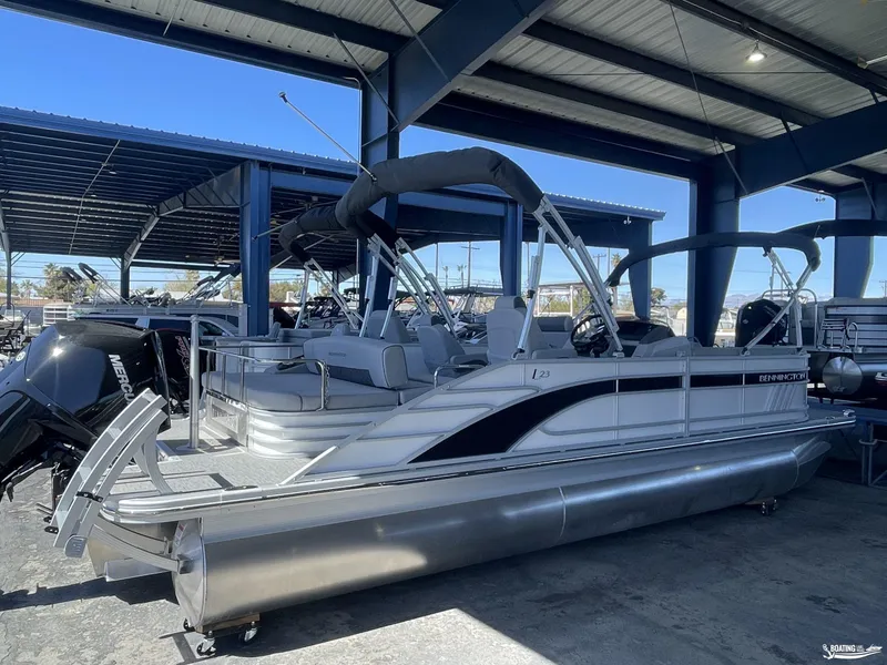 Slide: The Image of 2023 Bennington 23LSB pontoon boat in a covered marina, side view. - 3